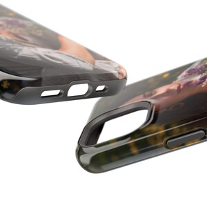 May include: A black phone case with a clear back that shows a photo of a person with flowers in their hair. The case has a raised lip around the camera lens and a cutout for the charging port.