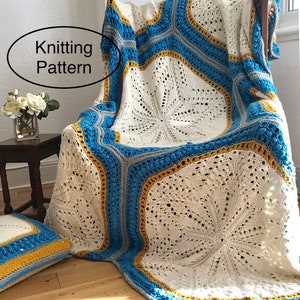 May include: A white crocheted blanket with blue and yellow stripes. The blanket is draped over a wooden chair. The text "Knitting Pattern" is visible in the image. The text "LooseLoop" is visible in the image.