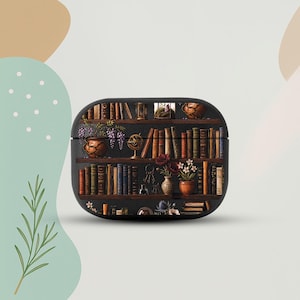May include: Black AirPod case with a detailed illustration of a bookshelf filled with books, vases, and decorative items. The design includes a globe, keys, and flowers, creating a vintage aesthetic. The case is a protective accessory for wireless earbuds.