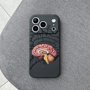May include: A black phone case featuring a detailed anatomical illustration of a human brain. The design includes a cross-section of the brain in shades of red, pink, and yellow, set against a dark background.