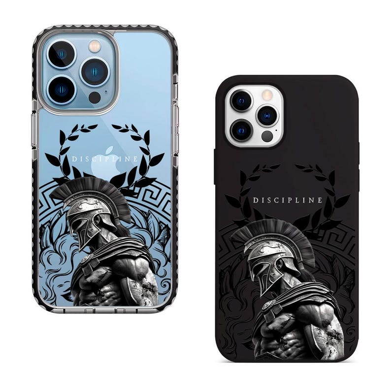 May include: Two phone cases with a black and white image of a Spartan warrior wearing a helmet and holding a spear. The image is surrounded by a laurel wreath and a Greek key pattern. The text "DISCIPLINE" is printed on the case.