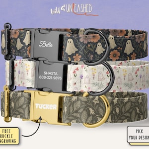 May include: Three dog collars with personalized buckles. The top collar has a black background with ghost and floral patterns. The middle collar has a white background with floral and ghost patterns. The bottom collar has a green floral pattern. The collars have metal hardware.