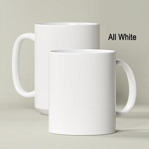 two white coffee mugs sitting next to each other