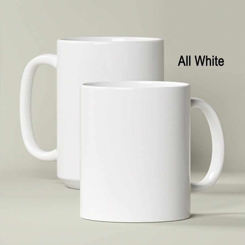 two white coffee mugs sitting next to each other