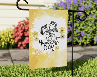 May include: A rectangular garden flag featuring a yellow watercolor background with a white center. A black line drawing of a Havanese puppy rests above the text Havanese DAY, surrounded by small yellow flowers on a black metal stand.