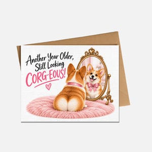 May include: A greeting card featuring a brown and white Corgi sitting on a pink circular rug, facing an ornate gold mirror. The Corgi wears a pink collar and bow. The text reads: Another Year Older, Still Looking CORG-EOUS! with a small pink heart.