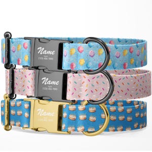 May include: Three dog collars with different birthday-themed patterns. The top collar has blue balloons, the middle collar has pink and white sprinkles, and the bottom collar has blue and white cake slices. Each collar has a black or gold metal buckle with a personalized name tag.