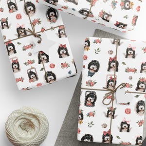 a table topped with wrapping paper and scissors