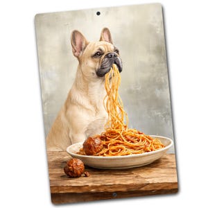 May include: A metal sign featuring a French Bulldog eating spaghetti from a white bowl. The dog is light brown with a black nose, and the spaghetti is orange. Two meatballs are visible on the wooden table.