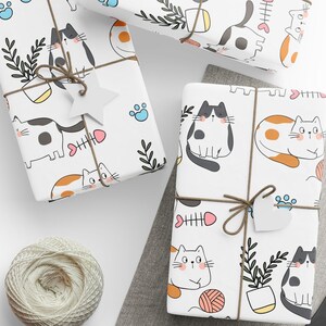 May include: White gift wrap with a repeating pattern of cute cartoon cats, fish bones, paw prints, and plants. The cats are in various poses and colors, including black, white, orange, and gray.