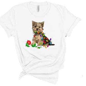 a white t - shirt with a small dog on it