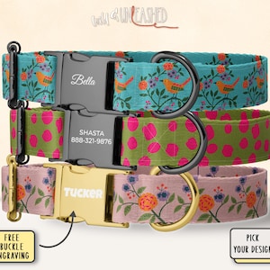 May include: Three personalized dog collars with metal buckles. The top collar is teal with orange birds and floral patterns. The middle collar is green with pink polka dots. The bottom collar is pink with orange and blue flowers. Each collar has a name engraved.