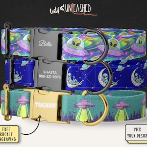 May include: Three pet collars with alien and UFO patterns. The top collar has a black buckle engraved with "Bella". The middle collar has a black buckle engraved with "SHASTA 888-321-9876". The bottom collar has a gold buckle engraved with "TUCKER".