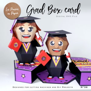 May include: A digital SVG file for a graduation box card. The card features two cartoon graduates, one female and one male, holding diplomas and books. The box is purple with gold stars and the text "Grad Box card" and "Digital SVG File".