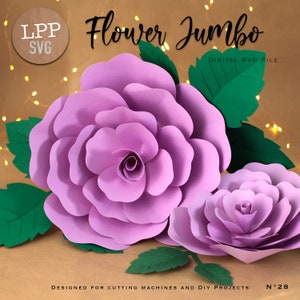 May include: A large, lavender paper flower with green leaves, and a smaller flower to the right. The text "Flower Jumbo" is above the flowers, with "DIGITAL SVG FILE" below. The bottom of the image reads "DESIGNED FOR CUTTING MACHINES AND DIY PROJECTS".