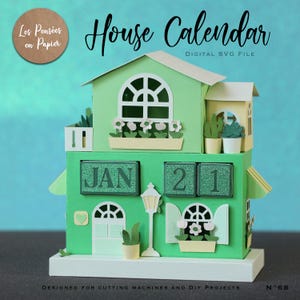 May include: A green paper house calendar with the date "JAN 21" displayed. The calendar has a house design with windows, flowers, and a small lamp post. The text "House Calendar" and "DIGITAL SVG FILE" are visible.