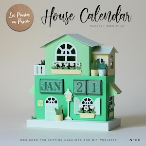 May include: A papercraft house calendar in shades of green, with the date January 21 displayed. The design includes miniature windows, doors, and flower boxes. Text on the image reads "House Calendar" and "Digital SVG File".