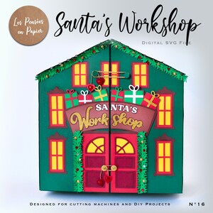 May include: A green papercraft Santa's Workshop with red doors, windows, and a sign that reads "SANTA'S Work Shop". The workshop is designed for cutting machines and DIY projects.