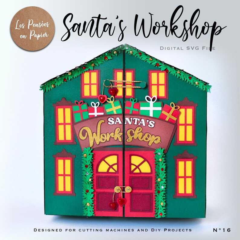 May include: A green papercraft Santa's Workshop with red doors, windows, and a sign that reads "SANTA'S Work Shop". The workshop is designed for cutting machines and DIY projects.