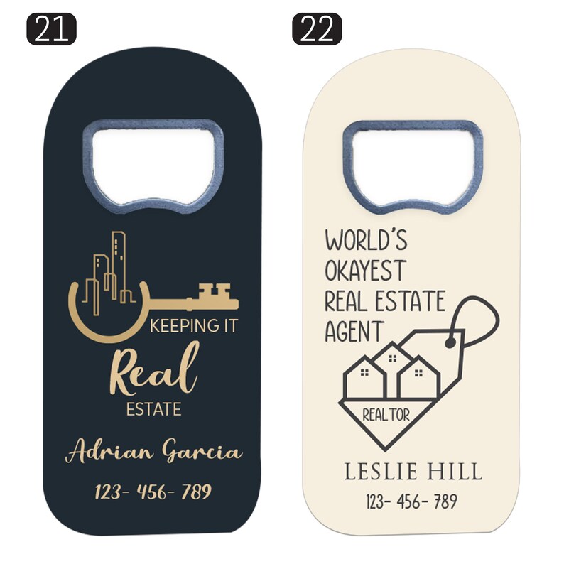 May include: Two flat, rectangular bottle openers with rounded tops. The left opener is dark navy with a gold key and city skyline graphic, text reading 'KEEPING IT Real ESTATE', 'Adrian Garcia', and '123-456-789'. The right is cream with black house icons, text reading 'WORLD'S OKAYEST REAL ESTATE AGENT', 'REALTOR', 'LESLIE HILL', and '123-456-789'.