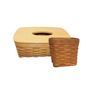 May include: Two woven baskets. One is a rectangular tissue box cover with a light wood lid and a round opening. The other is a small, square basket with a darker wood rim and a woven body.