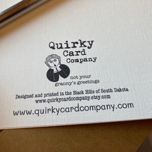 May include: Quirky Card Company logo with a cartoon illustration of a woman with a surprised expression. The text says "not your granny's greetings". The company website is www.quirkycardcompany.com.