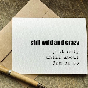 May include: A white card with black text that reads "still wild and crazy just only until about 9pm or so". The card is sitting on a brown paper background.