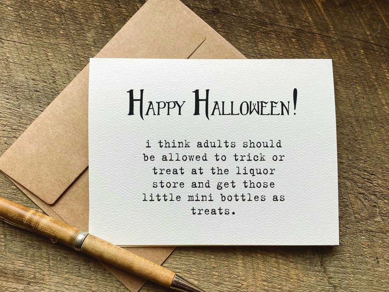 A funny white halloween greeting card with black text that reads 'HAPPY HALLOWEEN!' and 'i think adults should be allowed to trick or treat at the liquor store and get those little mini bottles as treats.'