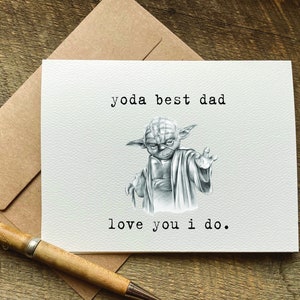 May include: A white card with a black and white illustration of Yoda from Star Wars. The text on the card reads "yoda best dad love you i do."