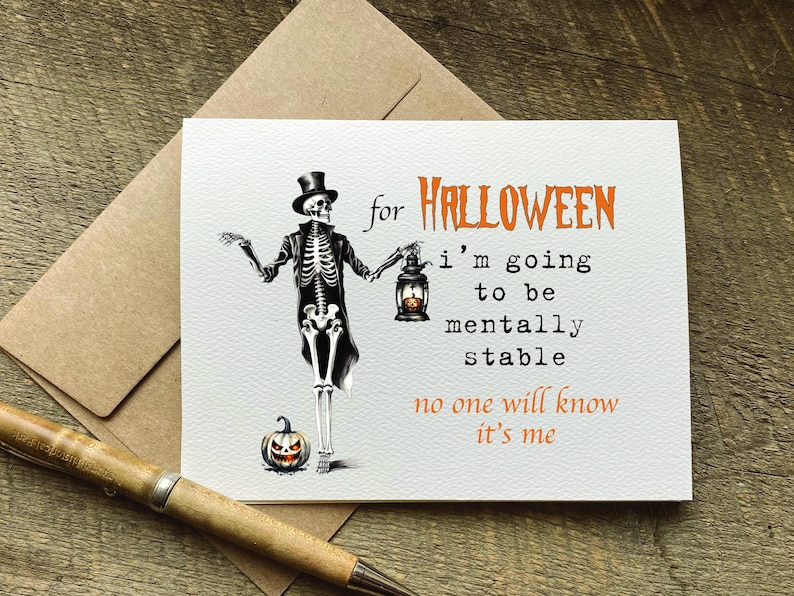 May include: A white greeting card featuring a skeleton wearing a top hat and tailcoat, holding a lantern with a glowing pumpkin inside. The text reads: for HALLOWEEN i'm going to be mentally stable no one will know it's me in orange and black.