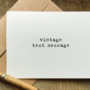 May include: A white card with the text "vintage text message" printed in black typewriter font.