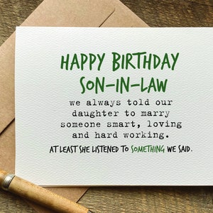 May include: A white card with green text that reads "Happy Birthday Son-In-Law. We always told our daughter to marry someone smart, loving and hard working. At least she listened to something we said."