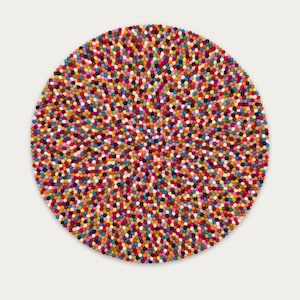 May include: A round, colorful rug made of felt balls. The rug is a mix of bright colors, including red, orange, yellow, green, blue, purple, and pink.