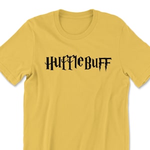 May include: A yellow t-shirt with the words "Hufflepuff" printed in black.