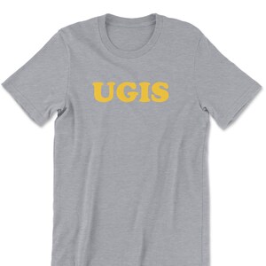 May include: A heather grey t-shirt with the word "UGIS" printed in yellow.