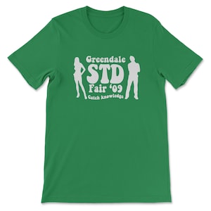 May include: Green t-shirt with a white graphic that says "Greendale STD Fair '09 Catch knowledge" with a silhouette of a man and woman on either side of the text.