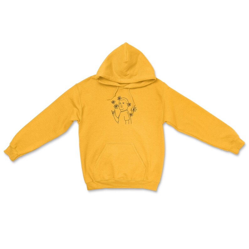 May include: A yellow hoodie with a black line drawing of a person with flowers around their head.