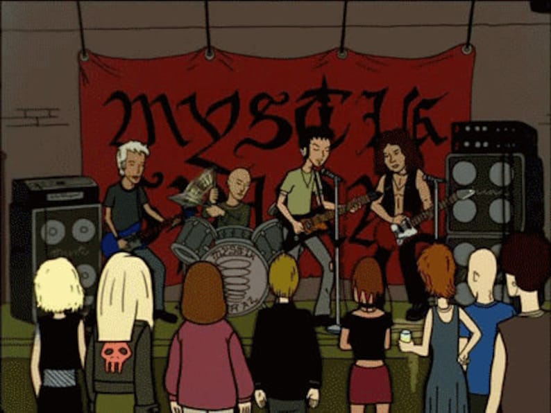 May include: A cartoon illustration of a band performing on stage with a red banner behind them that says "Mystik" in a gothic font. The band members are playing guitars and drums. There are people in the audience watching the performance.