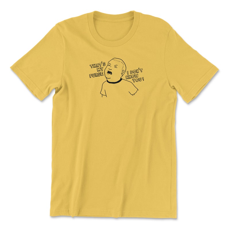 May include: A yellow t-shirt with a black and white cartoon image of a person saying "That's my purse! I don't know you!"