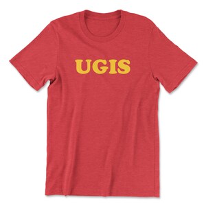 May include: Red t-shirt with the word "UGIS" printed in yellow.