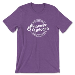 May include: Purple short-sleeved t-shirt with a white circle graphic that says "My horn can pierce the sky Princess Unicorn".