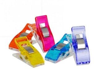 May include: Six colorful plastic clips for sewing or quilting. The clips are transparent and have a metal spring in the center. The colors are pink, orange, yellow, blue, and purple.