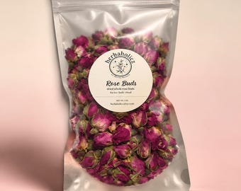 May include: A clear, resealable pouch filled with dried, deep pink rose buds. A circular white label on the front features the text 'herbaholicz', 'Rose Buds', 'dried whole rose buds', 'for tea-bath-ritual', 'net wt. 1 oz', and 'herbaholicz.etsy.com'.