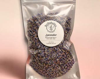 May include: A clear, resealable pouch filled with dried purple lavender flowers. A circular white label on the front features the text 'herbaholicz', 'Lavender', 'dried lavender flowers for tea bath ritual', and 'net wt. 1 oz'.