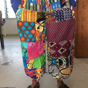 May include: Colorful patchwork pants with a variety of patterns and colors, including red, blue, green, yellow, and orange.