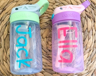 May include: Two Contigo water bottles. One is light blue with a green lid and the name "Jack" in turquoise. The other is purple with a pink lid and the name "Ella" in pink. Both bottles have a straw.
