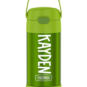 May include: Green Thermos water bottle with a handle and the name "KAYDEN" in white lettering. The Thermos logo is at the bottom. The bottle is green with a green lid and handle.