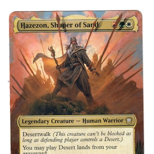 May include: A fantasy trading card featuring a legendary creature called Hazezon, Shaper of Sard. The card is illustrated with a human warrior standing in front of a desert landscape. The card text reads "Desertwalk (This creature can't be blocked as long as defending player controls a Desert.) You may play Desert lands from your graveyard. Whenever a Desert enters the battlefield under your control, create two 1/1 red, green, and white Sand Warrior creature tokens."