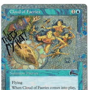 May include: A Magic: The Gathering card titled "Cloud of Faeries" with artwork of several faerie figures. The card has a blue and silver color scheme, with text that includes "Summon Faeries" and "Flying". The card is signed "THAT'S MY HAT!"