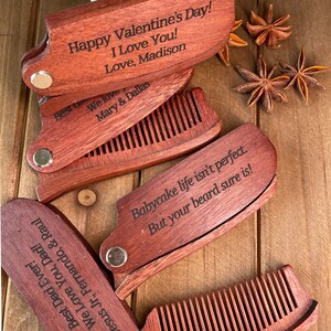 May include: Four wooden pocket combs with engraved messages. The top comb reads "Happy Valentine's Day! I Love You! Love, Madison". The second comb reads "We love Mary & Dallas". The third comb reads "Babycake life isn't perfect. But your beard sure is!" The fourth comb reads "Best Dad Ever! We Love You, Dad! Jesus Jr., Fernando, & Raul".
